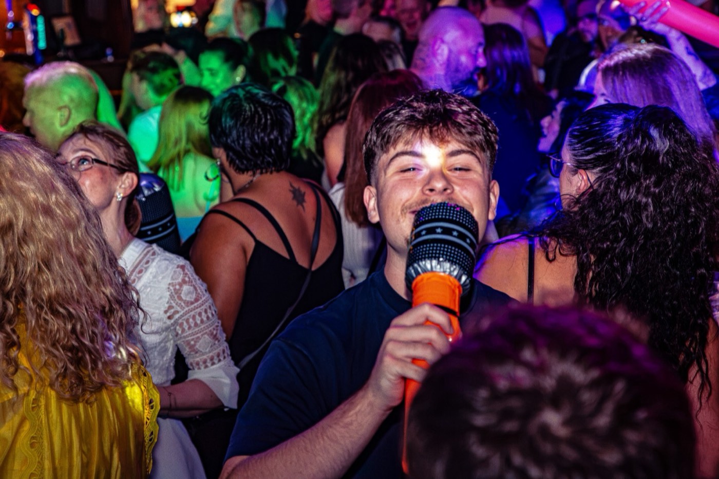 A guest singing into an inflatable microphone