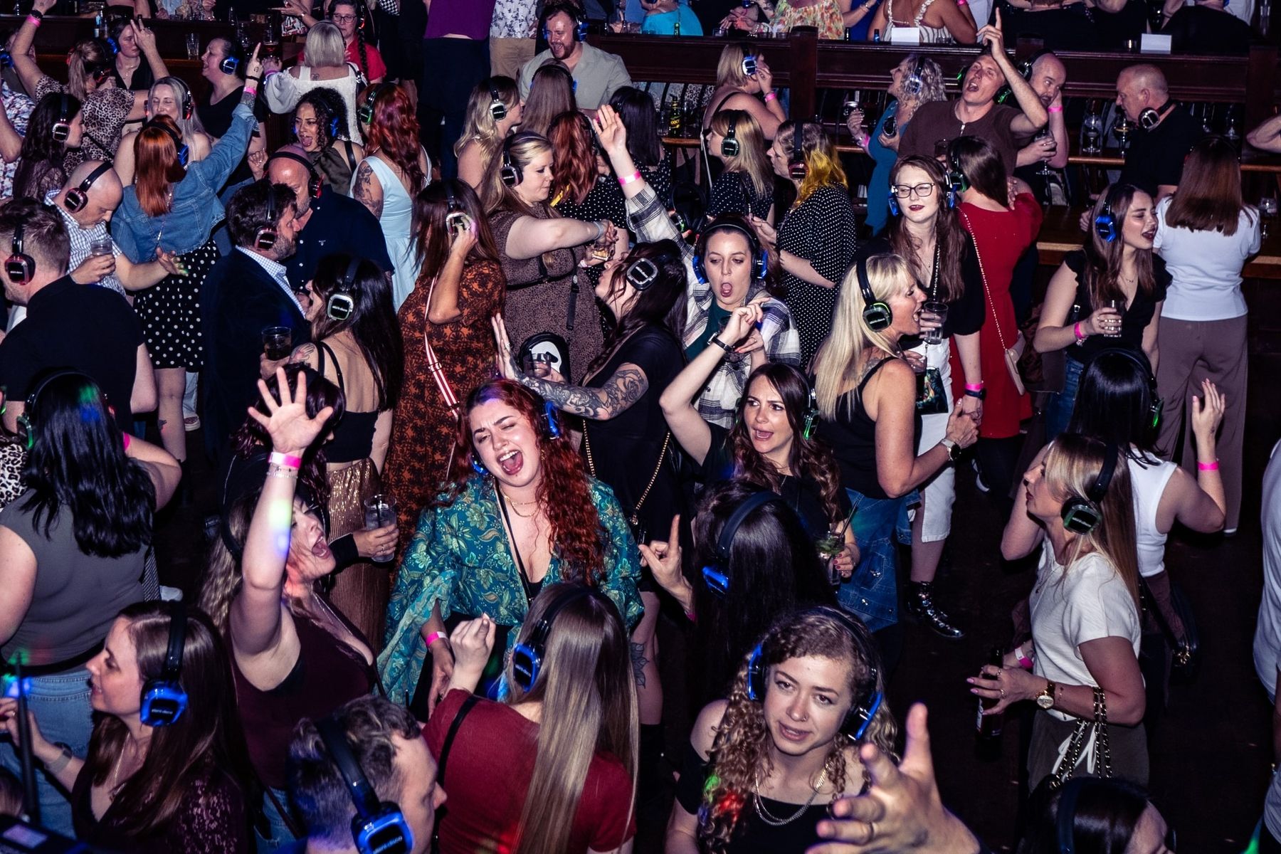 Guests dancing in light-up silent disco headphones